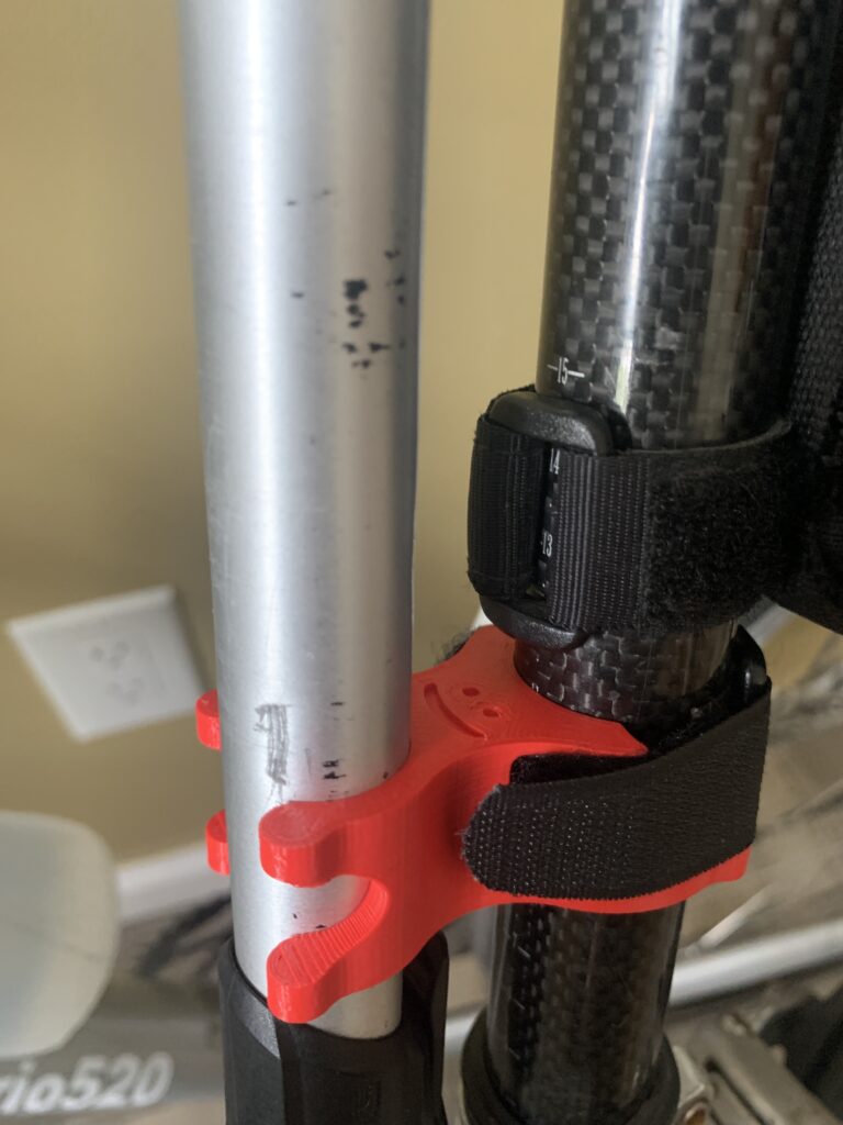 3D Printed bike pump bracket. Red. Smiley face, happy!