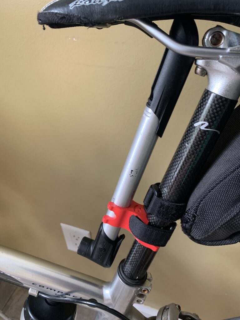 3D Printed bike pump bracket. Red. Smiley face, happy!