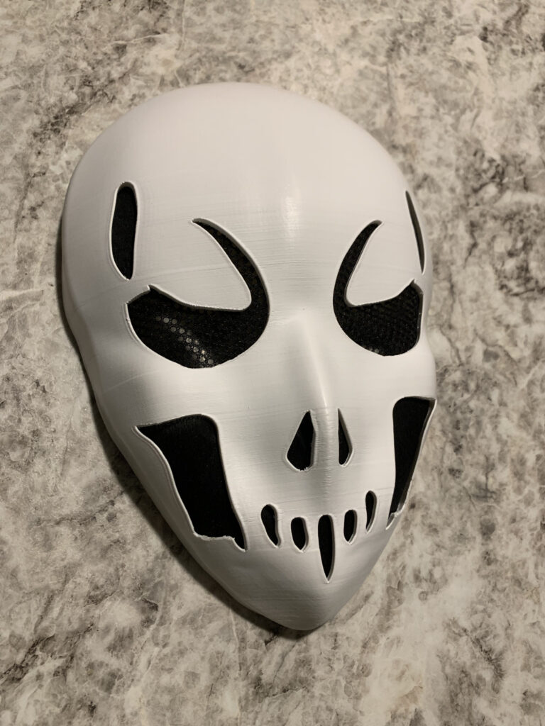 I had the privilege of working on my first custom build as a gift for someone’s husband back Fall of 2023. She asked me to physically create a mask based on this AI generated image she created. It was a great project that involved lots of surface modeling and therefore lots of fine tuning! White 3D printed. final version